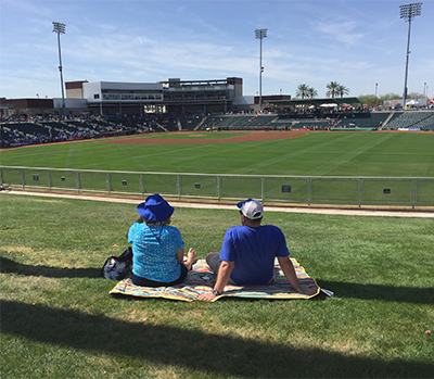 Spring training fans relaxed on outfield grass berm